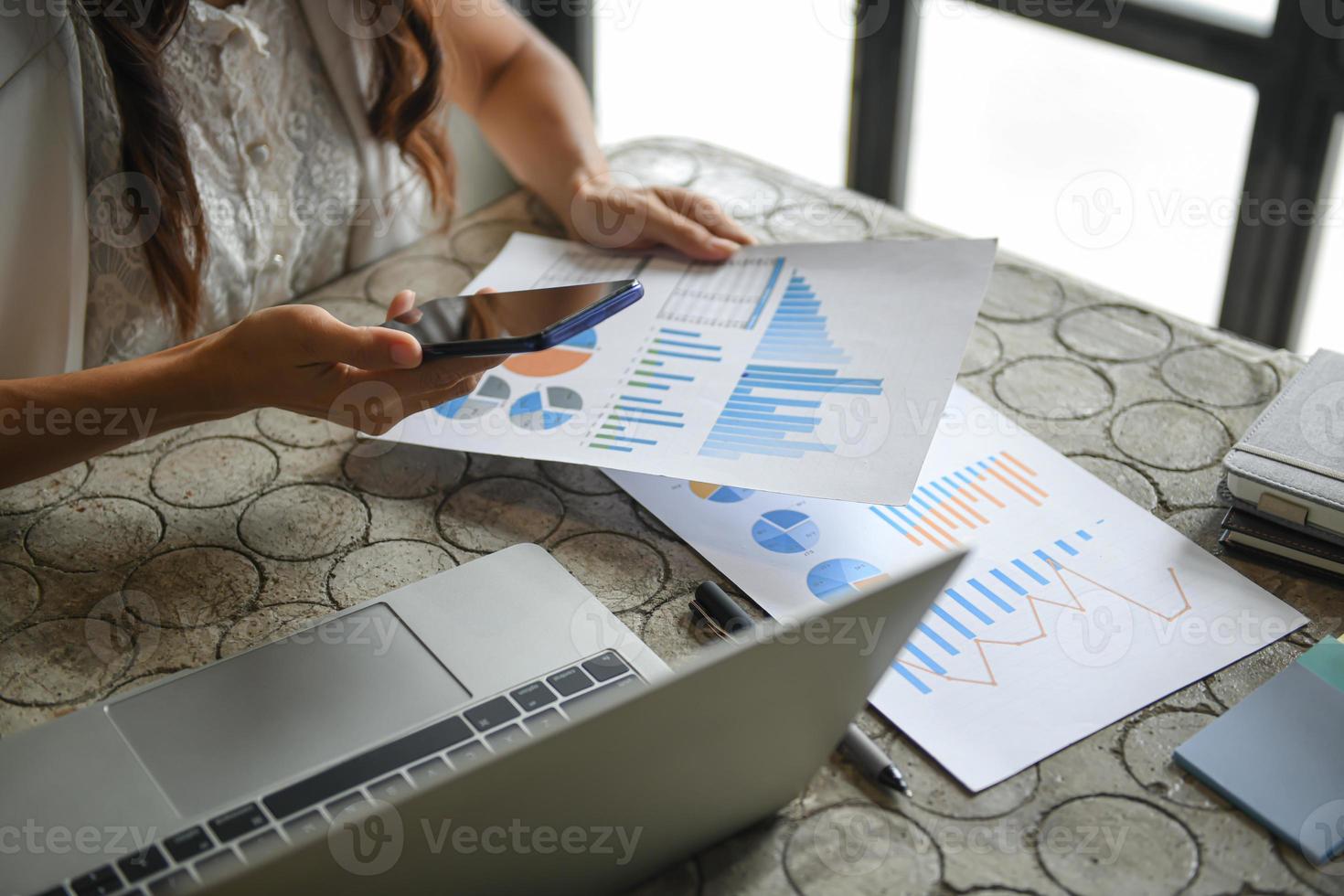 Hand of a business woman is using a mobile phone to find information. photo