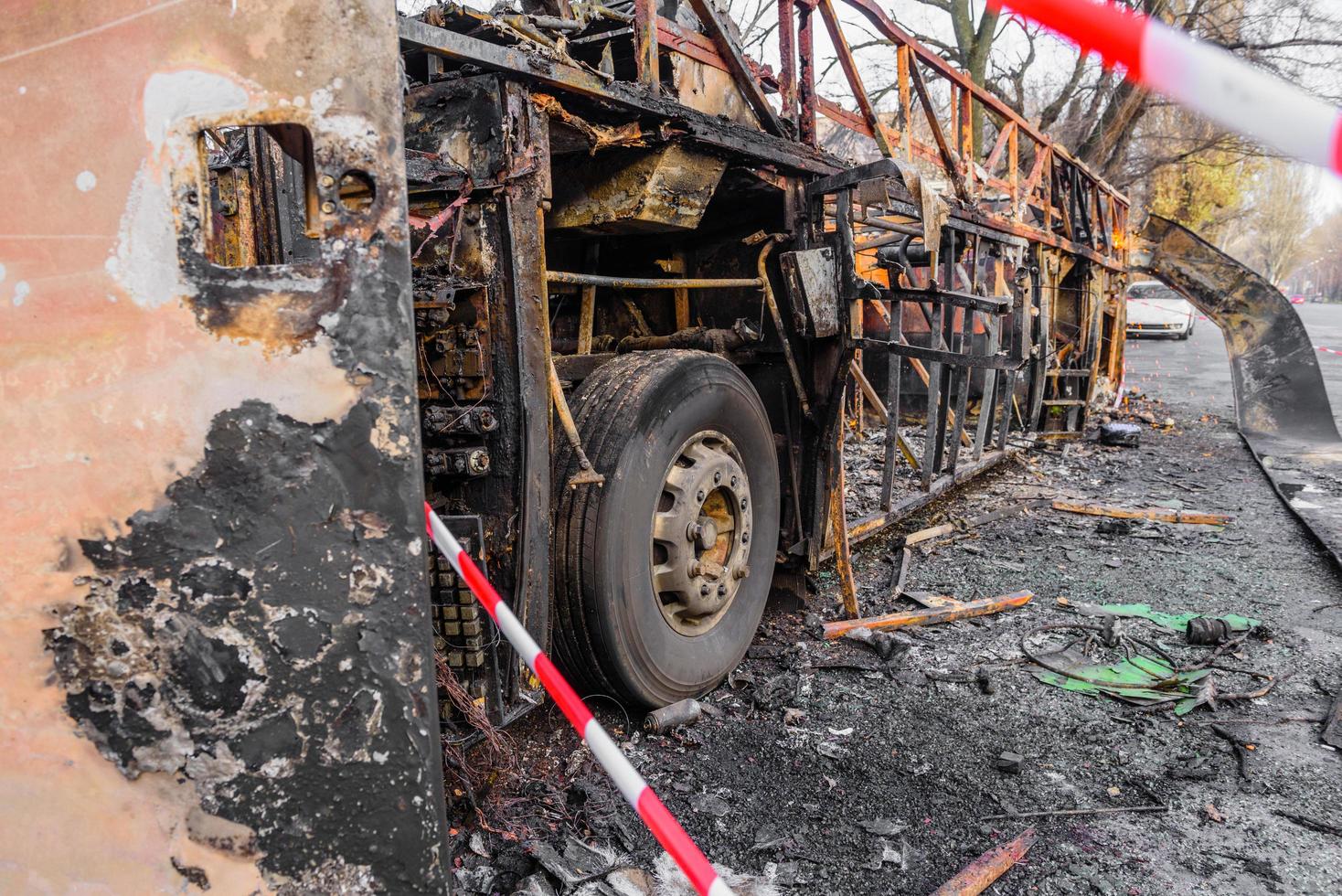 Burnt bus is seen on the street after caught in fire during travel, after fire photo