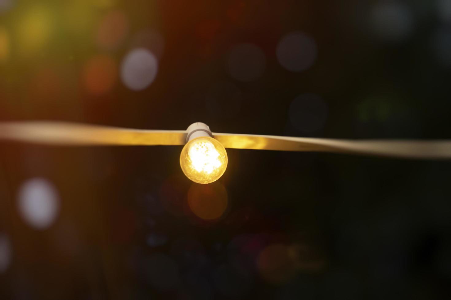 Yellow light bulbs on a blurry background with bokeh photo