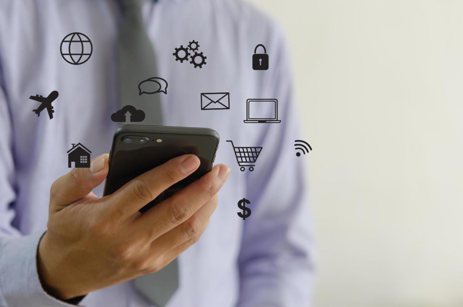Hand holding smartphone with icons concept. Hand use smartphone online shopping Social media network concept. photo