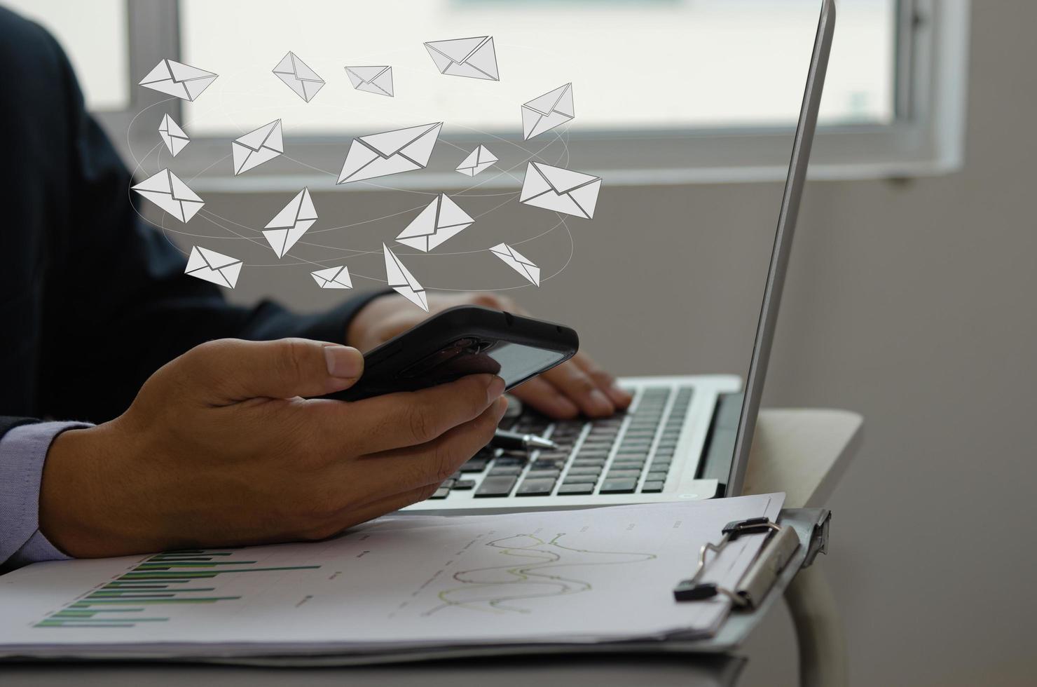 Close-up man holding a cell phone an icon email message. Marketing business sending information to customers or hacking online transactions. Business concept technology. photo