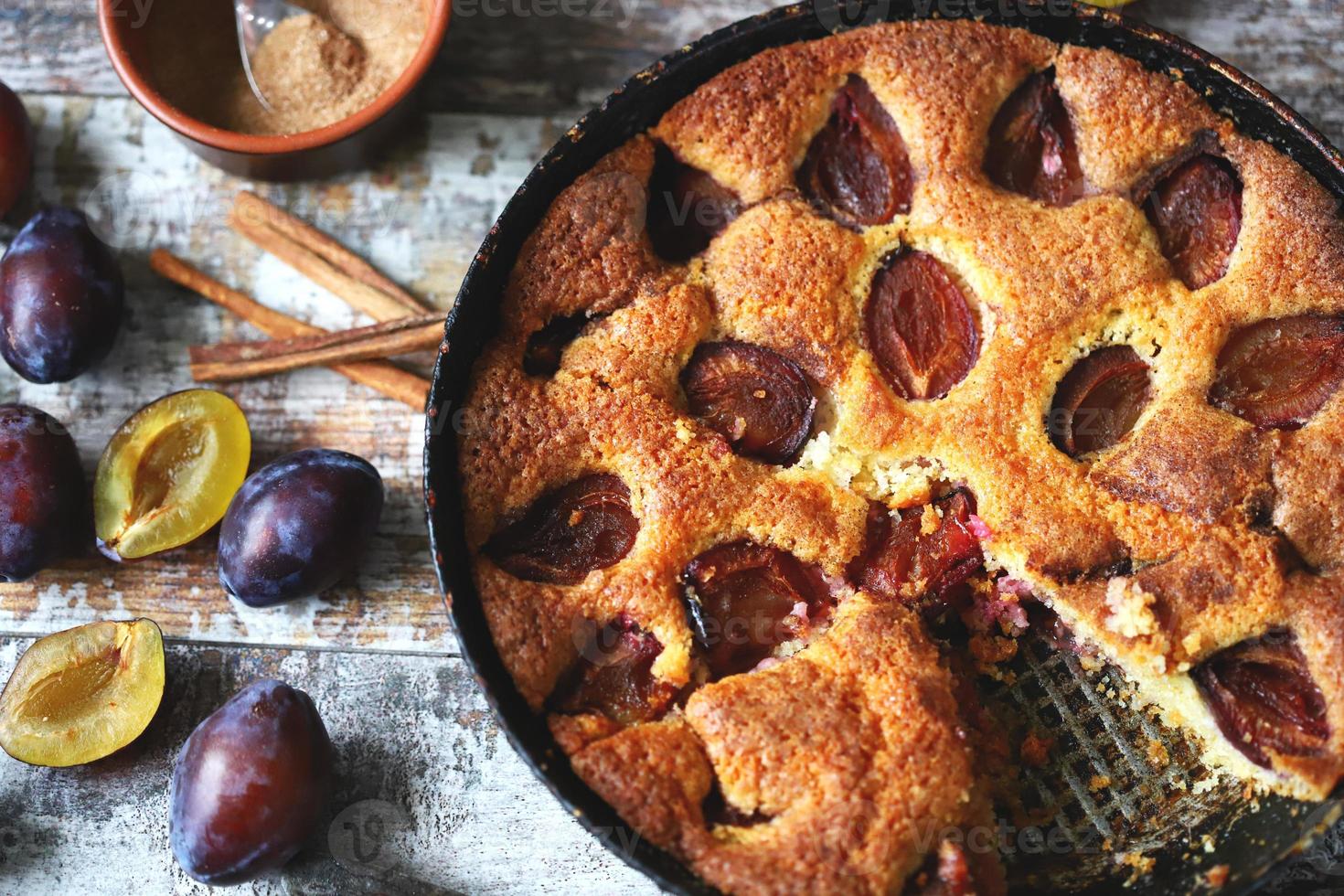 Slice of plum pie on a fork Homemade American plum pie. photo