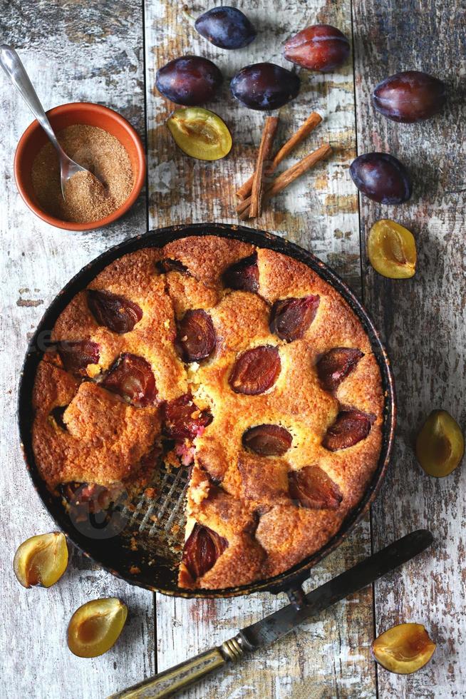 Slice of plum pie on a fork. Homemade American plum pie. photo