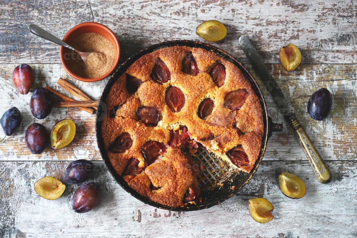 Slice of plum pie on a fork. Homemade American plum pie. photo