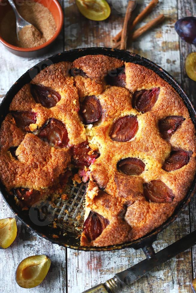 Slice of plum pie on a fork. Homemade American plum pie. photo