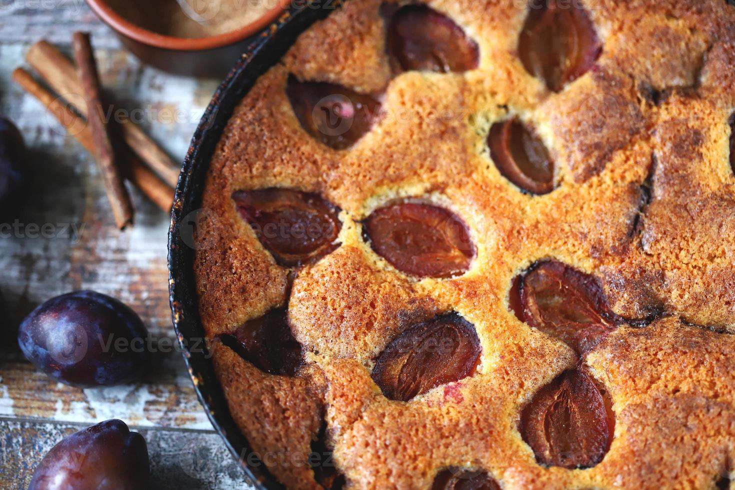 Slice of plum pie on a fork. Homemade American plum pie. photo