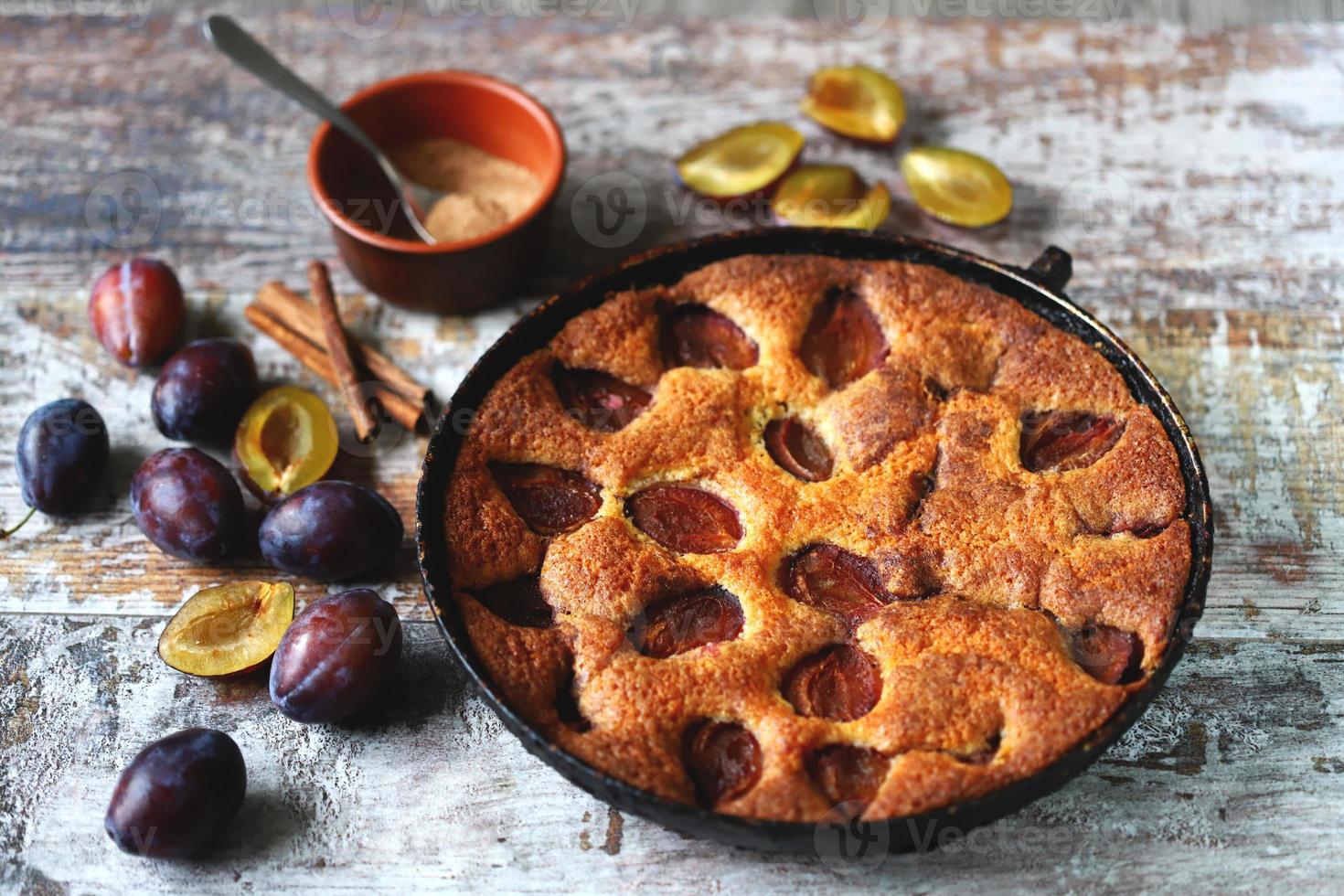 Slice of plum pie on a fork. Homemade American plum pie. photo