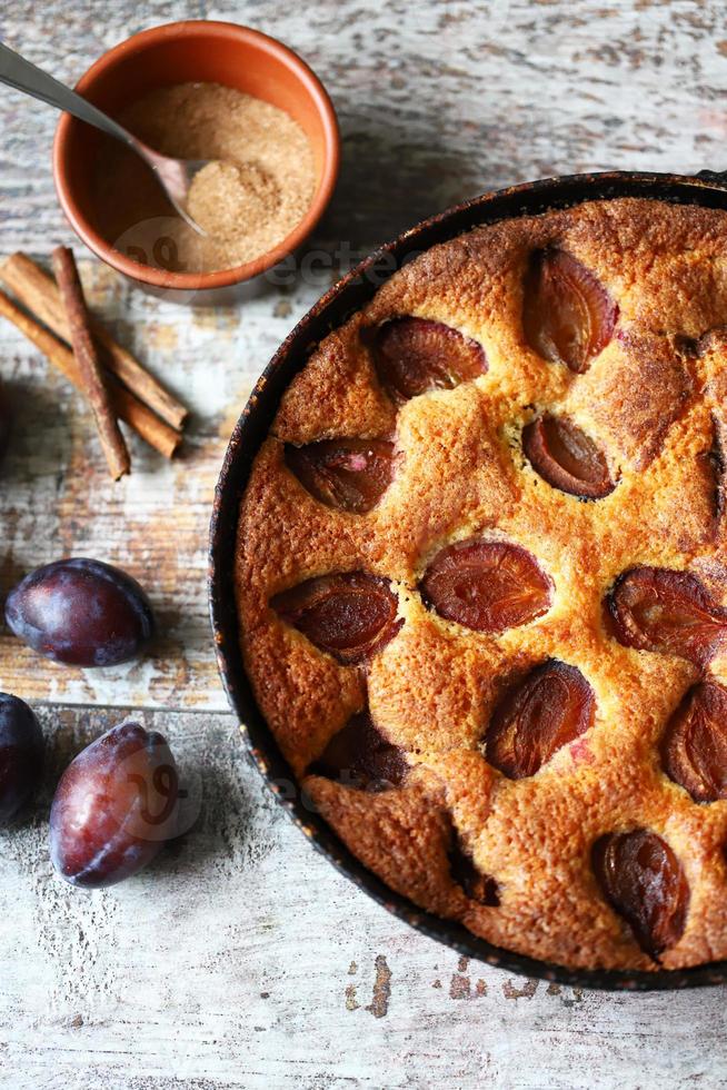 Slice of plum pie on a fork Homemade American plum pie. photo