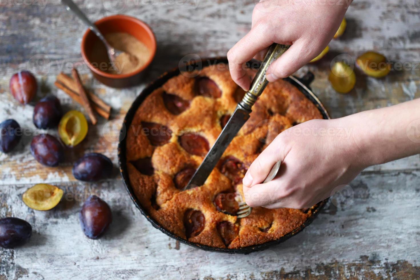 Slice of plum pie on a fork Homemade American plum pie. photo