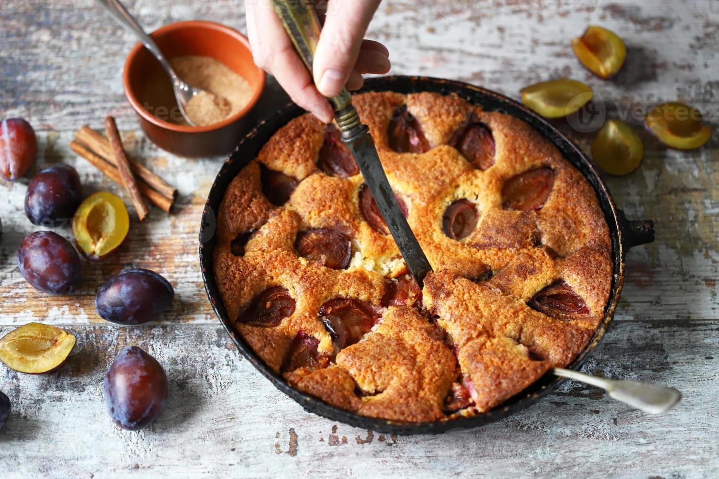 Slice of plum pie on a fork Homemade American plum pie. photo