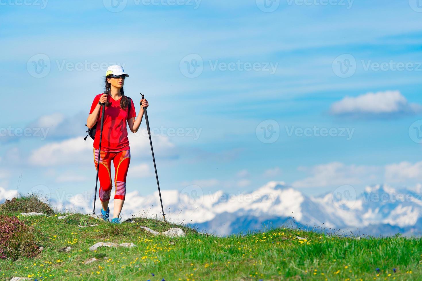 turista mujer vestida de rojo con altas montañas con nieve foto