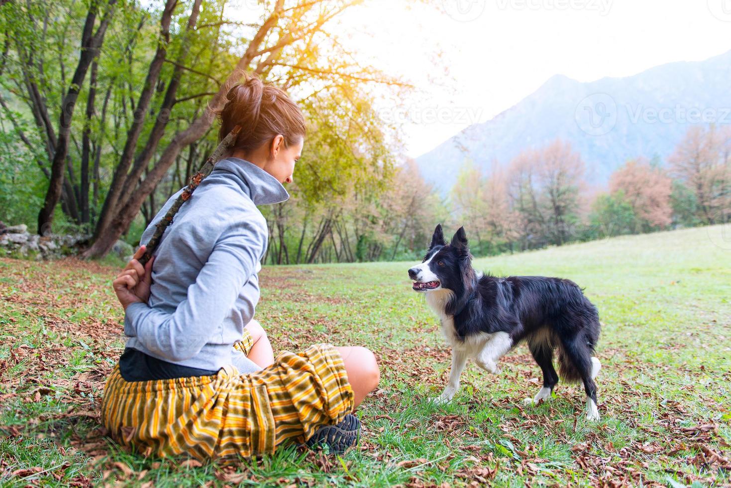 Girl playing with her dog border collie photo