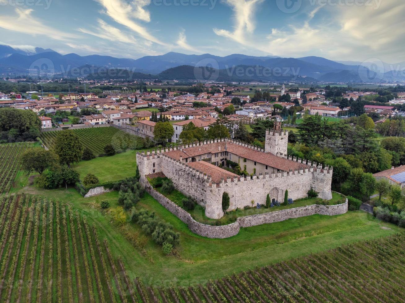 Aerial view of a medieval castle surrounded by vineyards photo