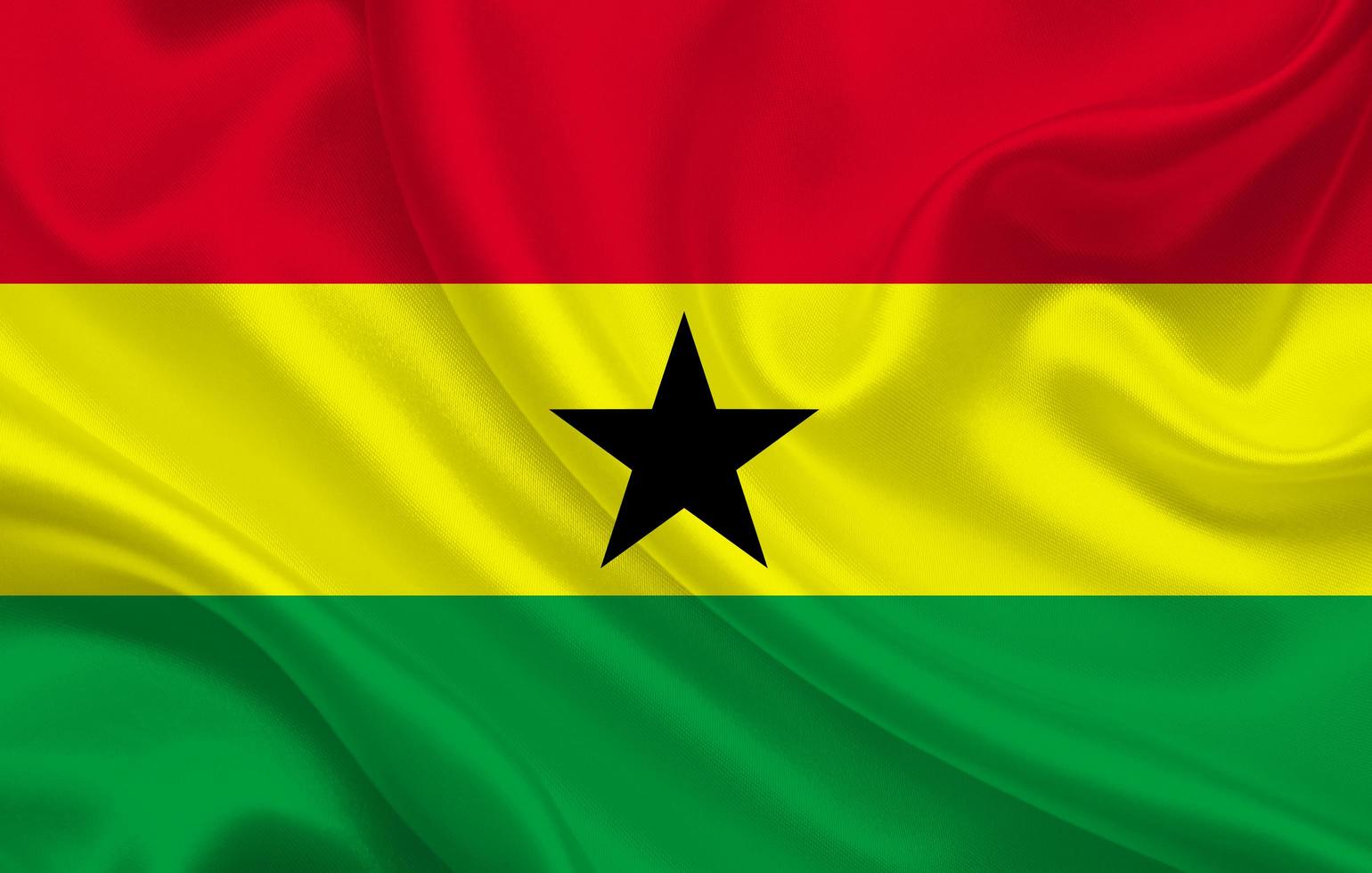 Bandera del país de Ghana sobre fondo de seda ondulada foto