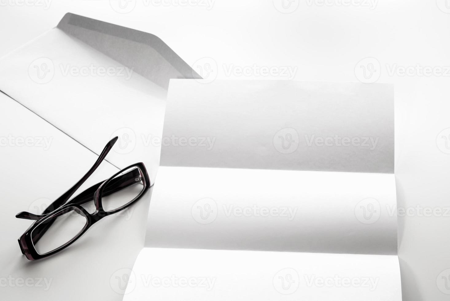 Espacio en blanco de papel de carta y sobre con anteojos foto