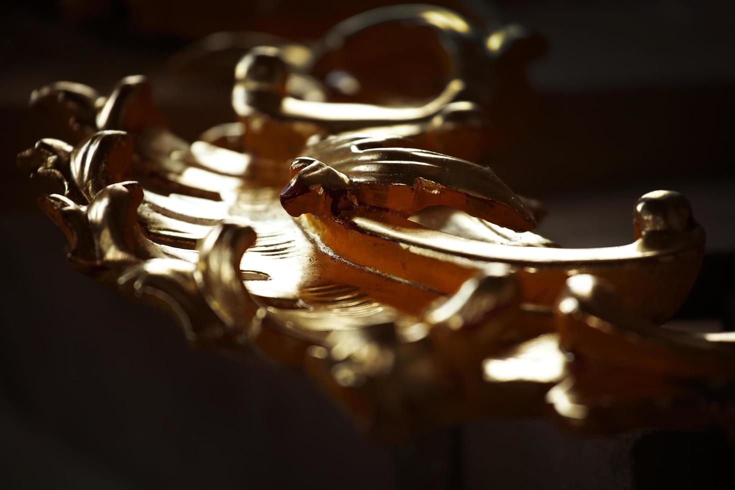 Fragment of an old wooden gilded ornament photo