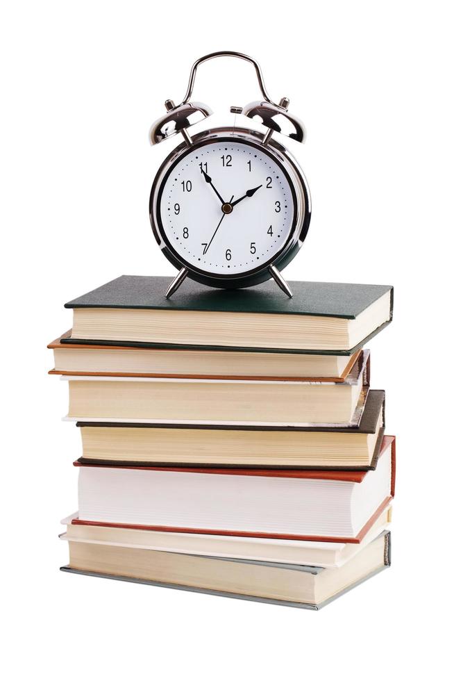 Alarm clock with a stack of books photo