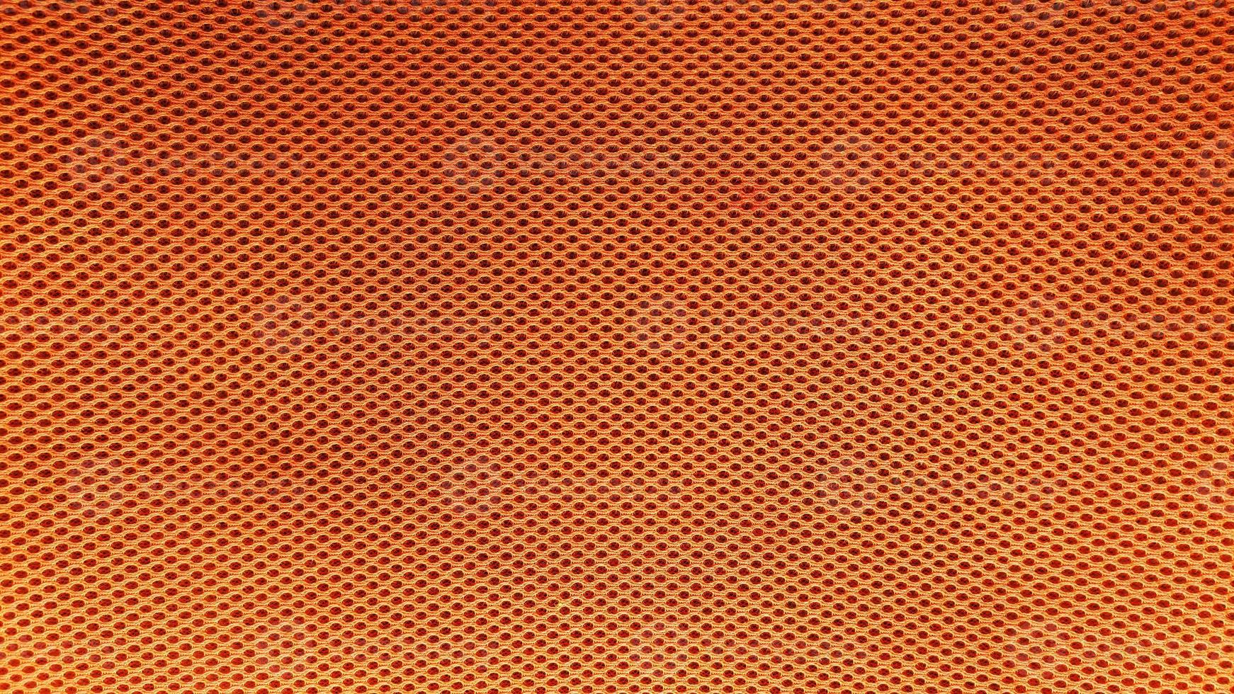 Fondo de textura de patrón de tela de nylon naranja. foto