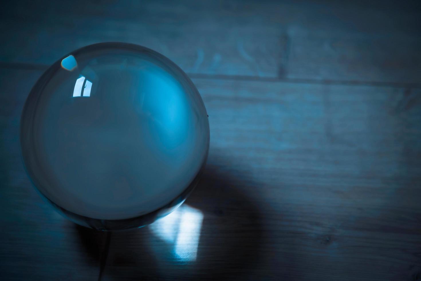 Blue ball of Glass reflecting light photo