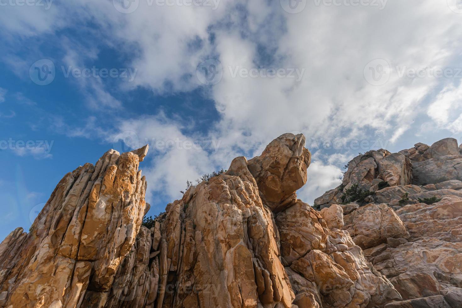 Stones of various shapes weathered by the sea under the blue sky photo