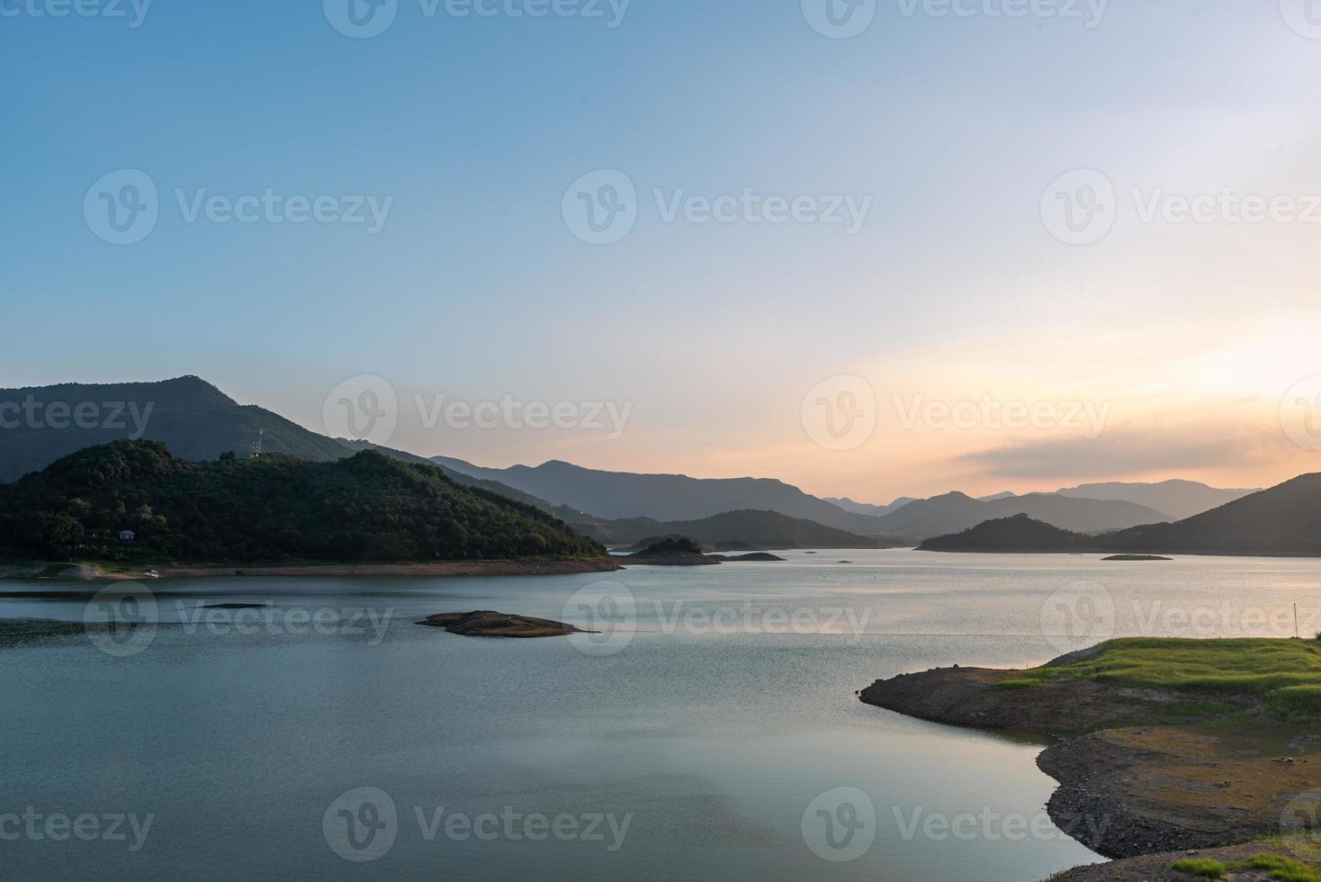 el lago de la tarde reflejaba las montañas y el cielo a ambos lados foto