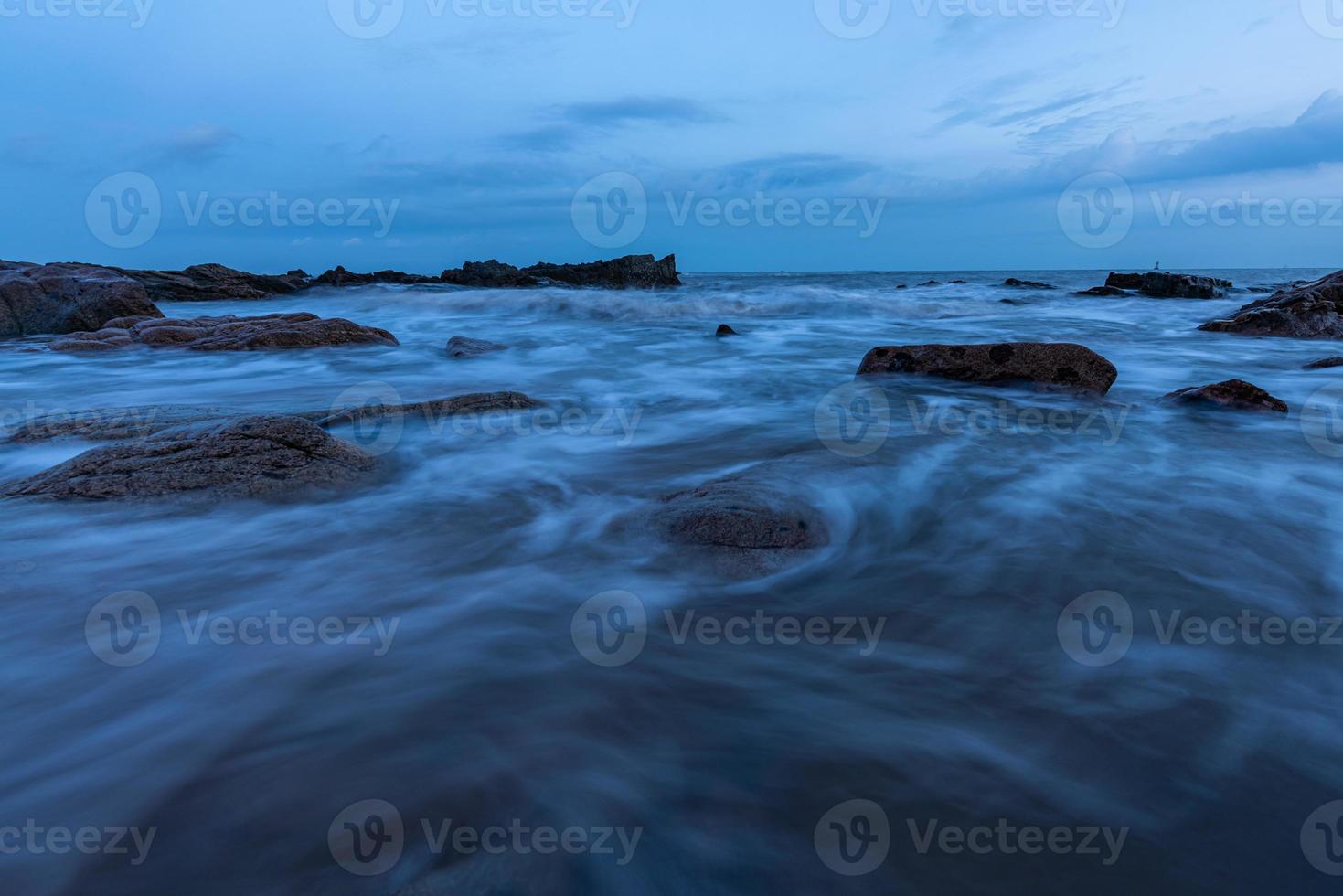 In the evening, the sea slapped the rocks photo
