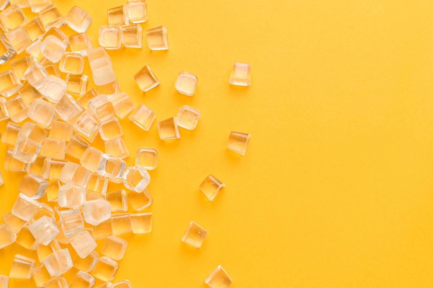 ice cubes, cold on a yellow background photo