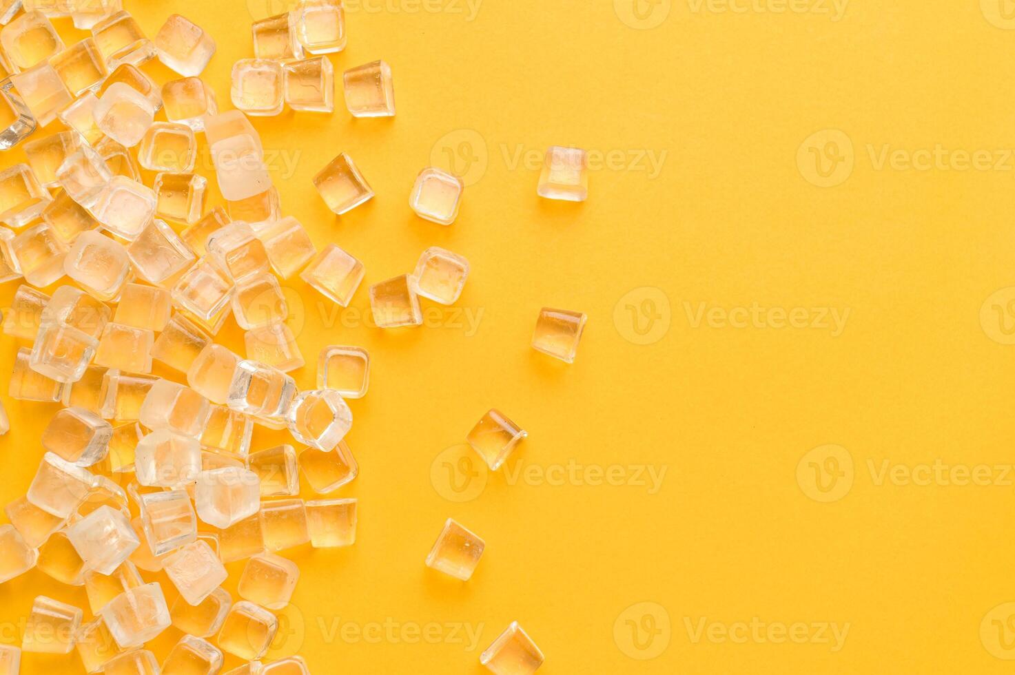 A yellow background with many small pieces of plastic photo