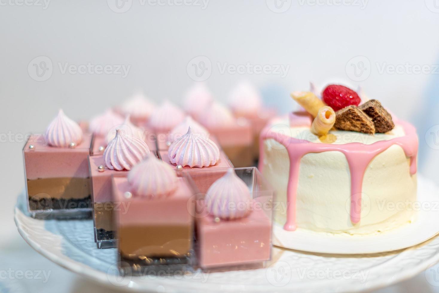 The pink cake is on the white table photo