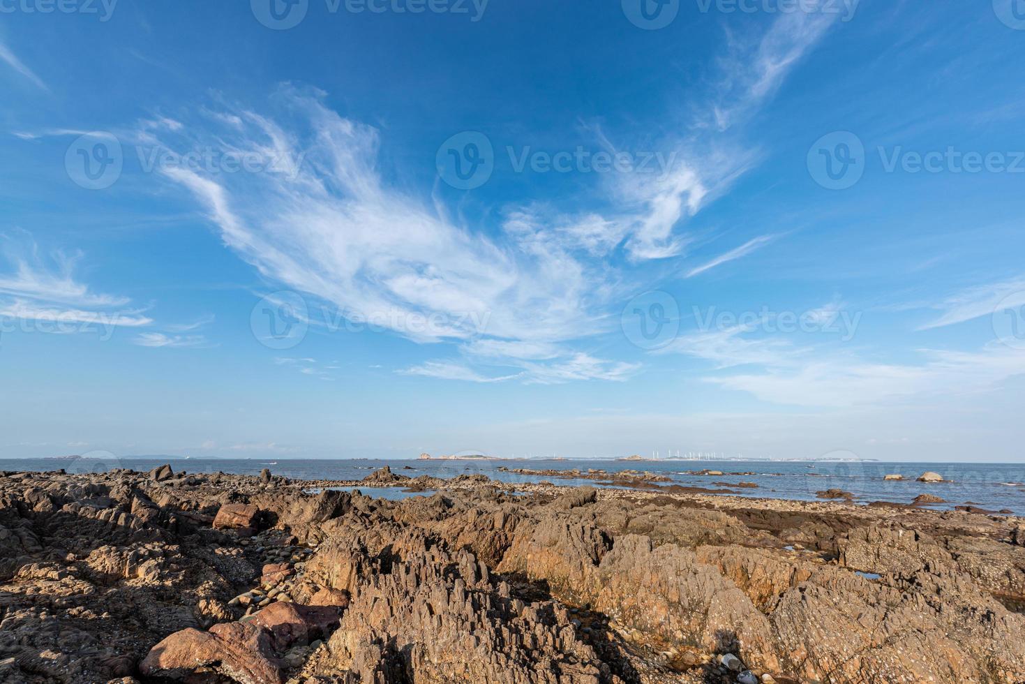 Yellow reef and sea under the blue sky photo