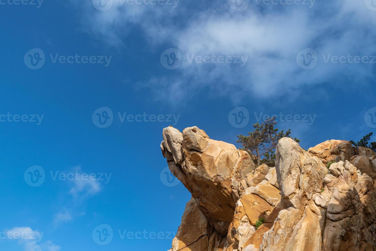 Stones of various shapes weathered by the sea under the blue sky photo