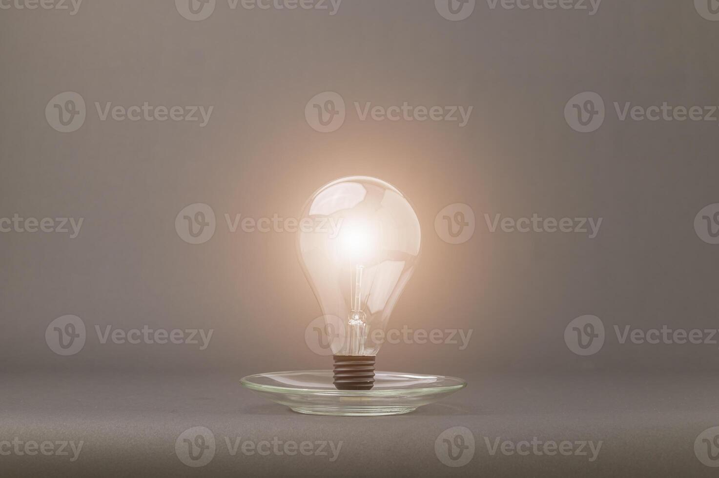A light bulb is on top of a glass plate photo