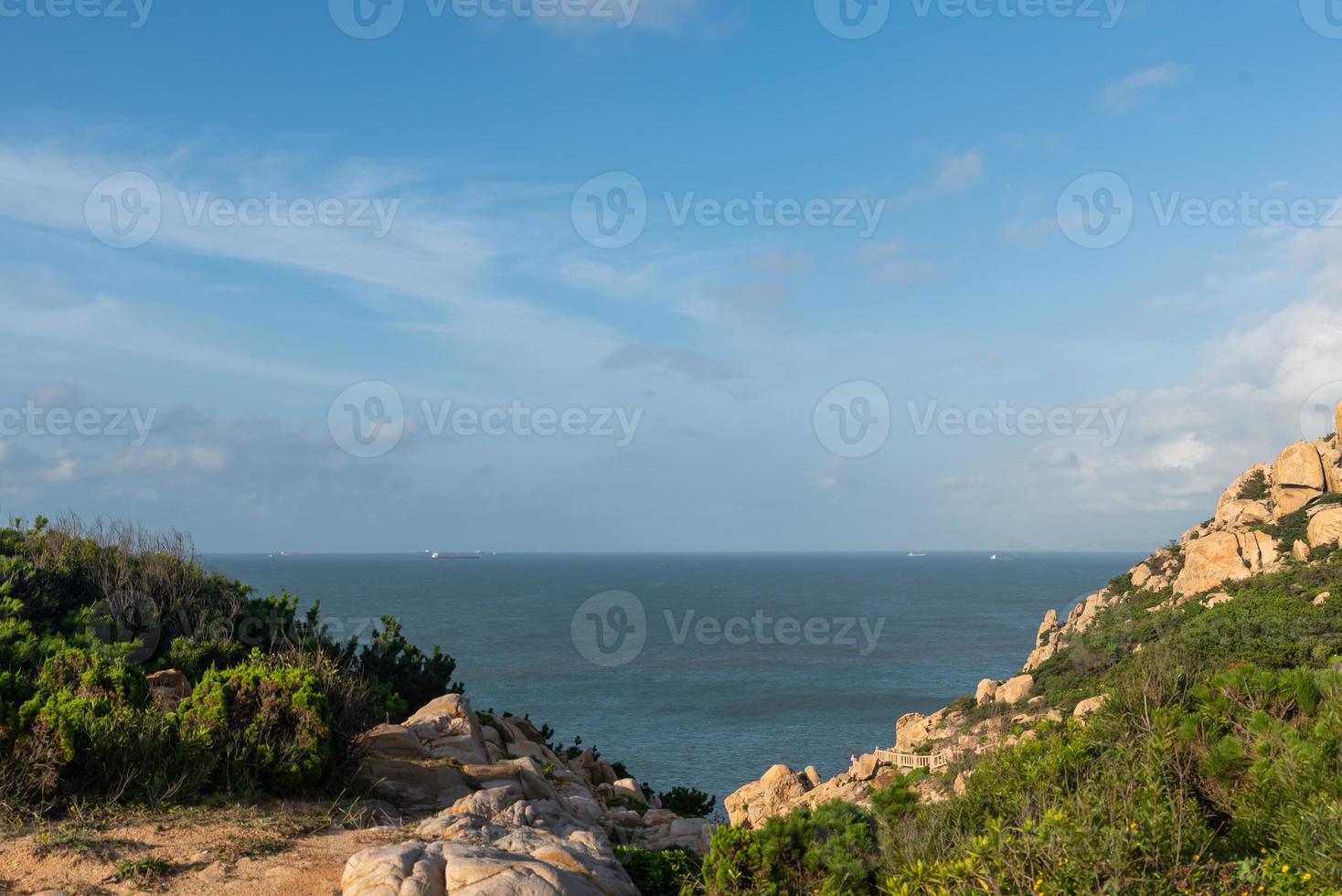 Stones of various shapes weathered by the sea under the blue sky photo