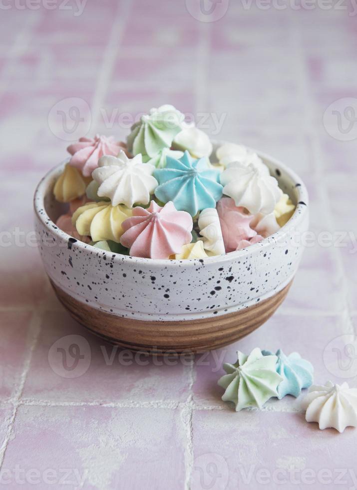 Small colorful meringues in the  ceramic bowl photo