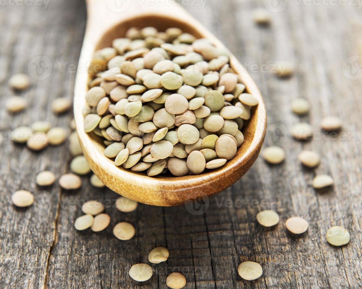 Raw lentil in spoon photo