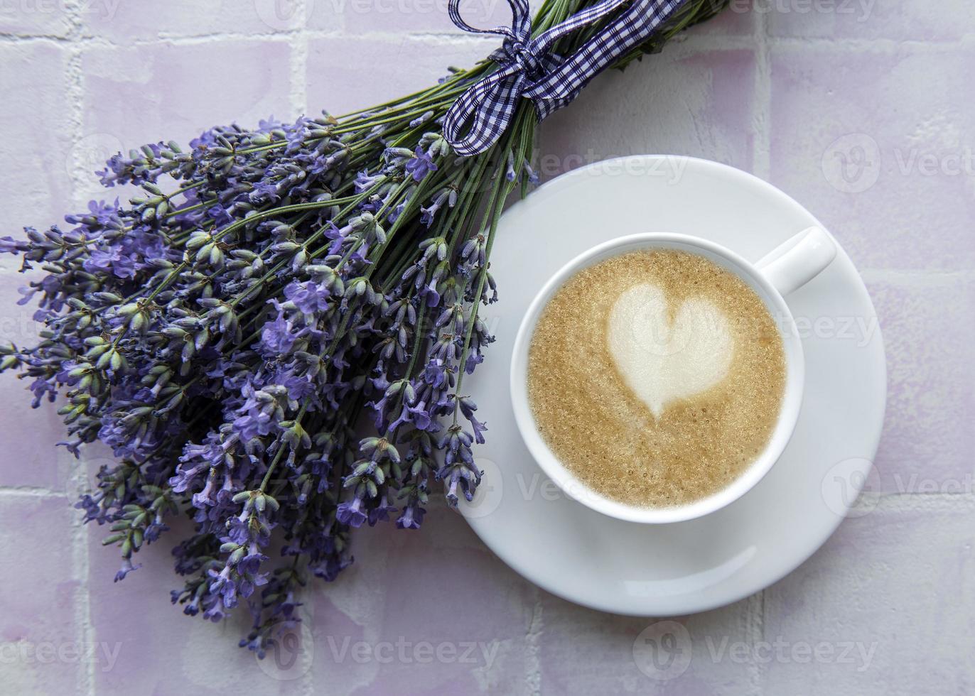 Cup of coffee with macaroon dessert with lavender flavor photo