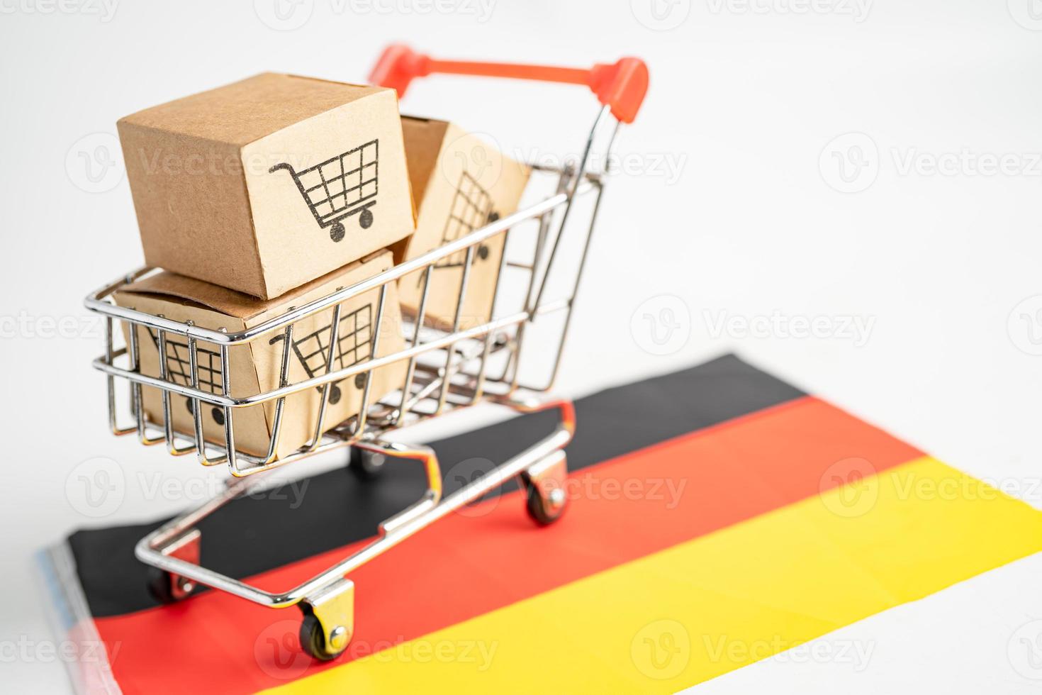 Caja con logotipo de carrito de compras y bandera de Alemania, importación, exportación, compras en línea o comercio electrónico, servicio de entrega de finanzas, tienda, envío de productos, comercio, concepto de proveedor. foto