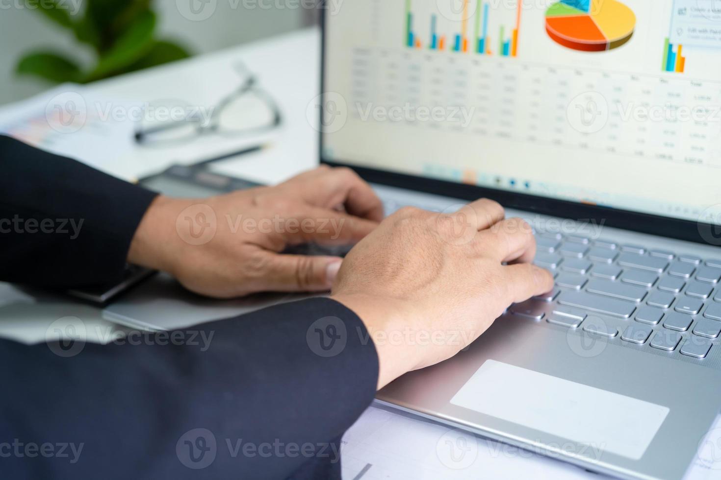 Asian accountant working and analyzing financial reports project accounting with chart graph in modern office, finance and business concept. photo