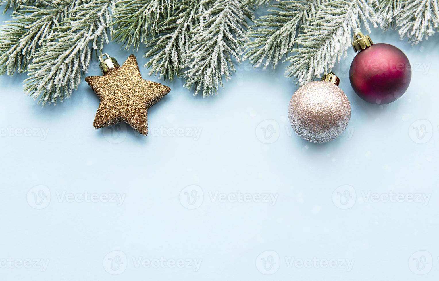 Christmas minimal concept - Christmas composition with snowy fir branch and  baubles photo
