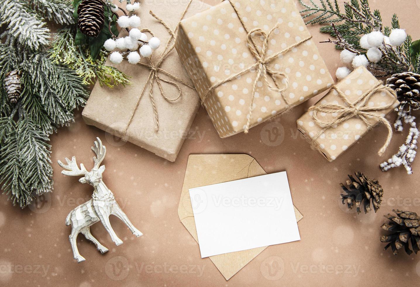 Christmas composition with card, deer, gift boxes and fir branches. photo