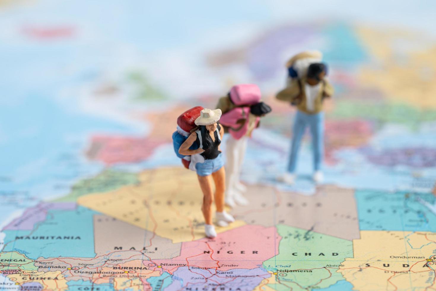 Bangkok, Thailand, July 30, 2021 Miniature people,Backpacker enjoy to discovery journey travel at amazing on world map. photo