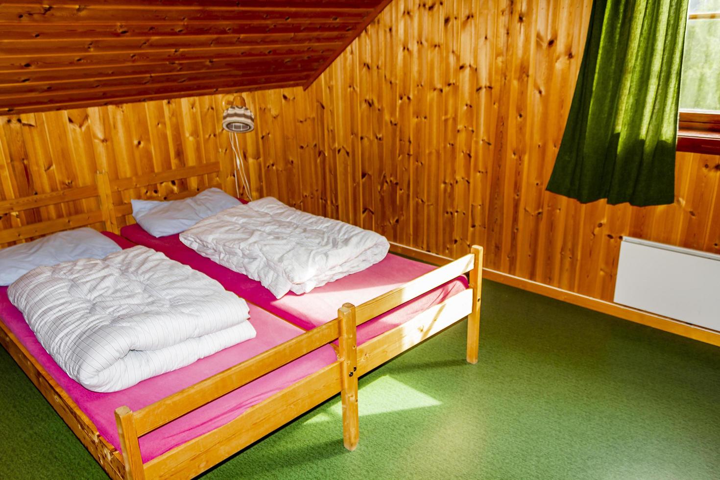 Cottage vacation interior decoration. Bedroom with beds in Norway photo