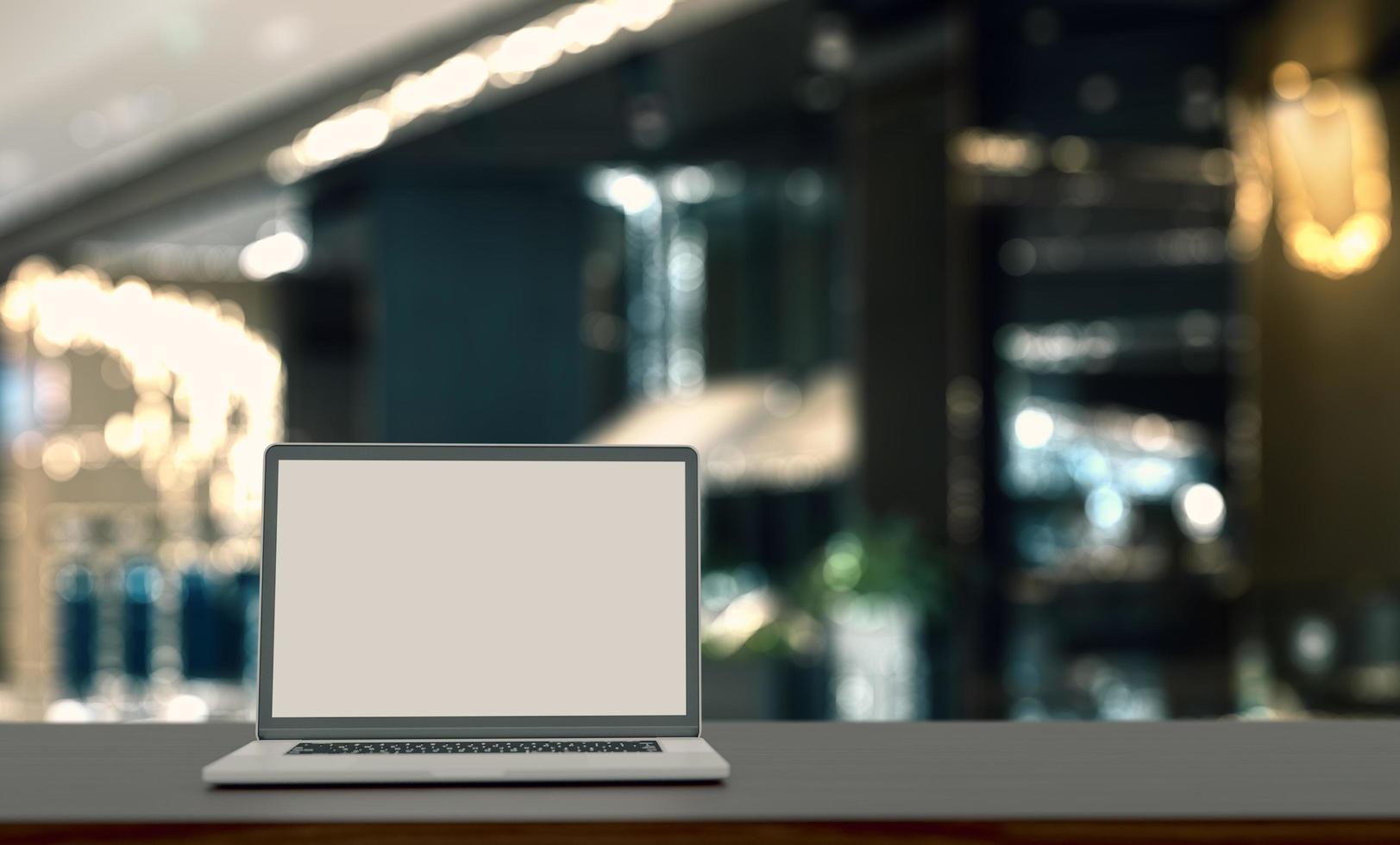 laptop blank screen on wooden table with blured background. photo