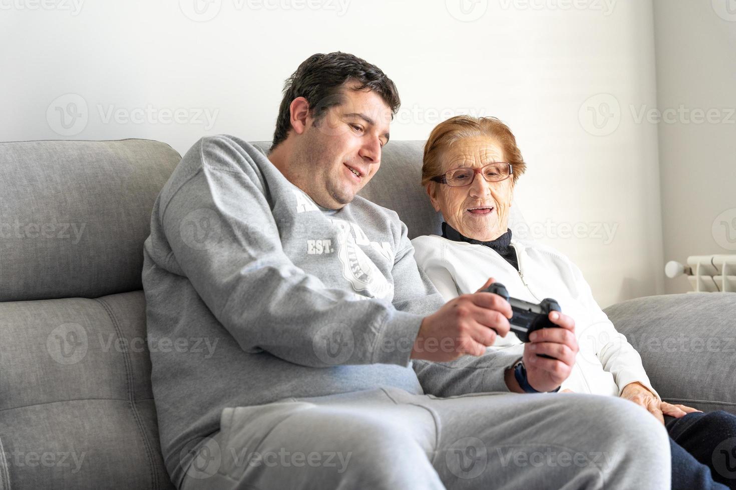 Adult man and senior woman with gamepad at home photo