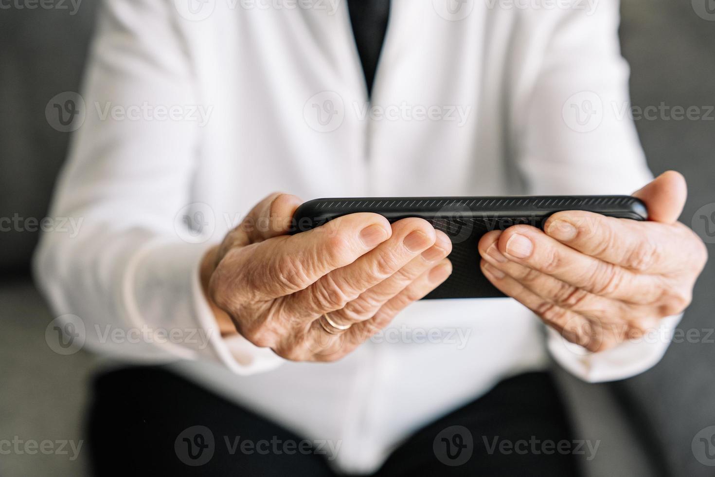 Smiling senior woman having video call on smartphone photo