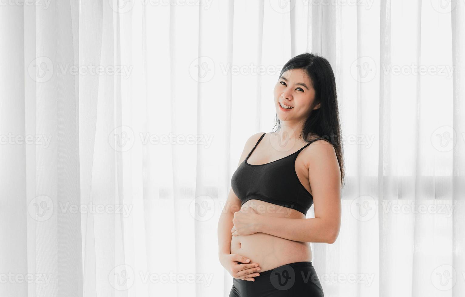 Two month pregnant Asian woman photo