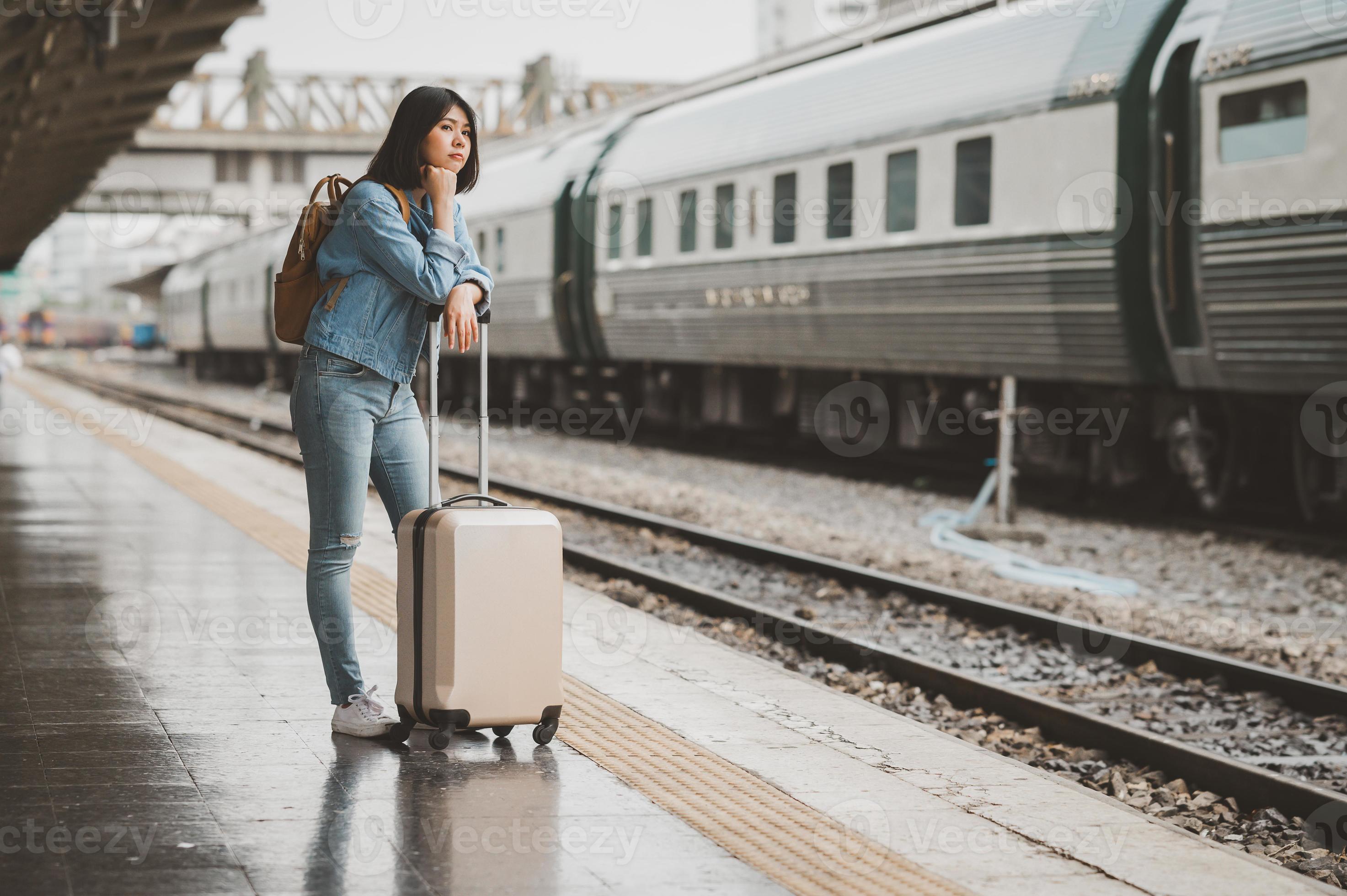 Asian woman waiting for train at train station platform 3605193 Stock Photo at Vecteezy