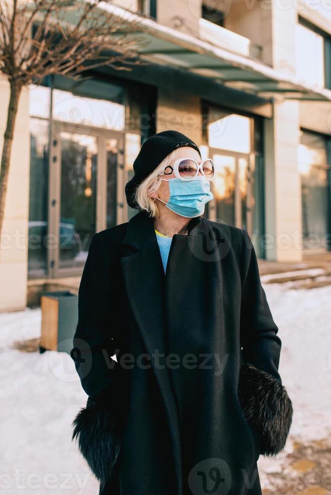 mujer con estilo senior en boina y elegante abrigo negro y médica caminando al aire libre. bloqueo, pandemia, concepto de protección 3606206 Foto de stock en Vecteezy