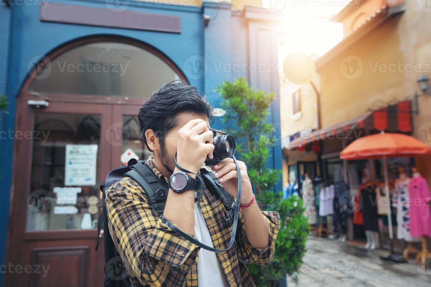 Asian men backpacks walking together and happy  are taking photo and selfie ,Relax time on holiday concept travel