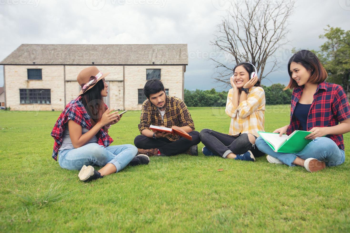 Group Students Smile and have fun and listen to music It also helps to share ideas in the work and project And also review the book before the exam outdoor in the garden. photo